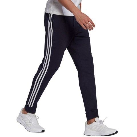 Spodnie męskie adidas Essentials Fleece Tapered Cuff 3-Band Pants granatowe GK8823 Adidas
